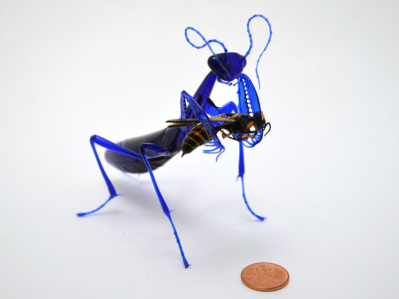 Indigo Mantis Eating Wasp, glass vignette by Wesley Fleming